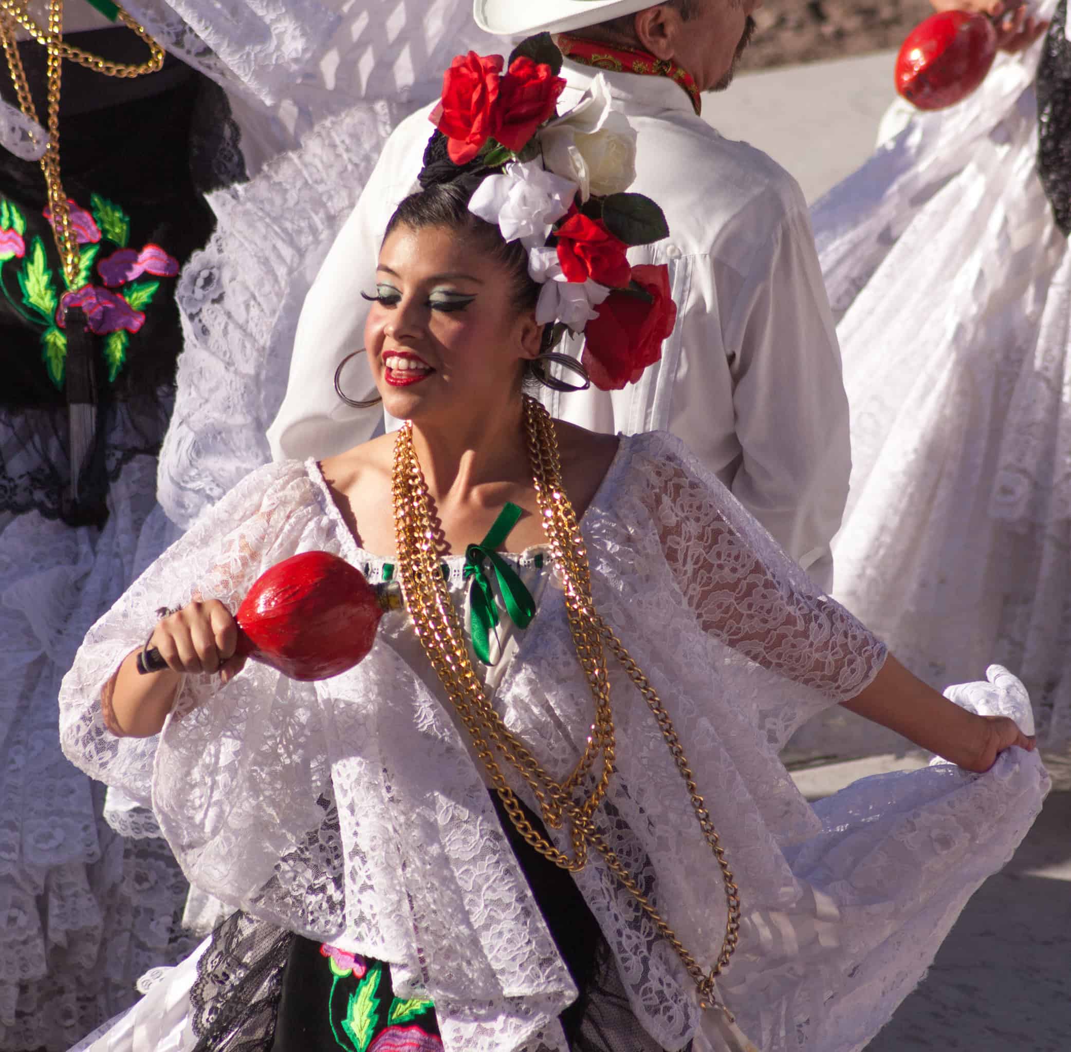 Vibrant woman in traditional Mexican dress celebrating cultural heritage and festivities in San Miguel.