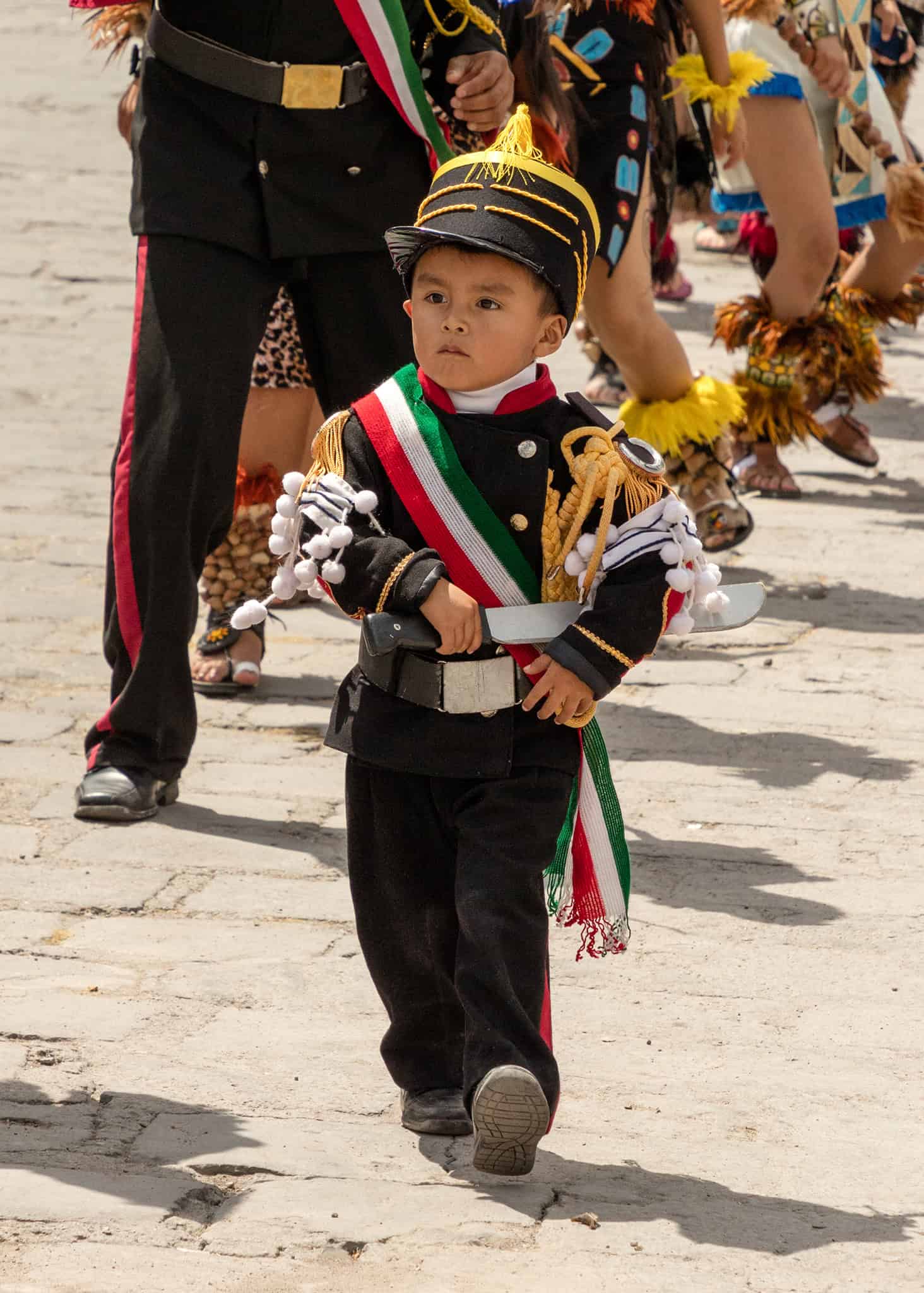Young boy dressed as a Mexican military officer with decorative uniform, during cultural event in San Miguel de Allende.
