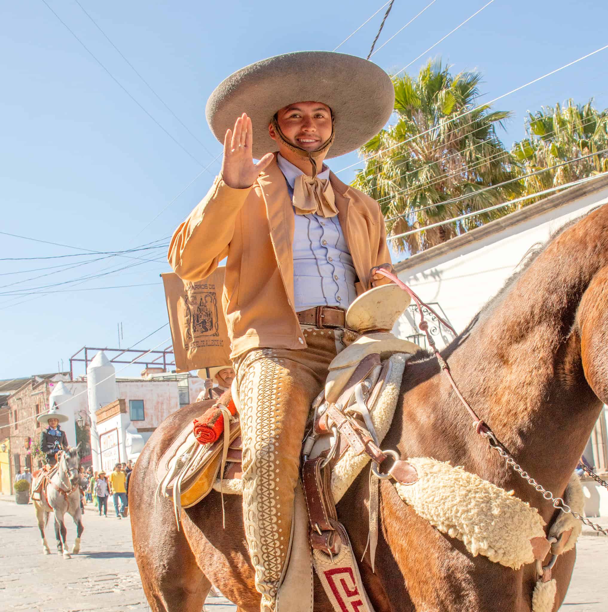 Colorful Mexican charro riding horse during cultural parade in San Miguel, Mexico.