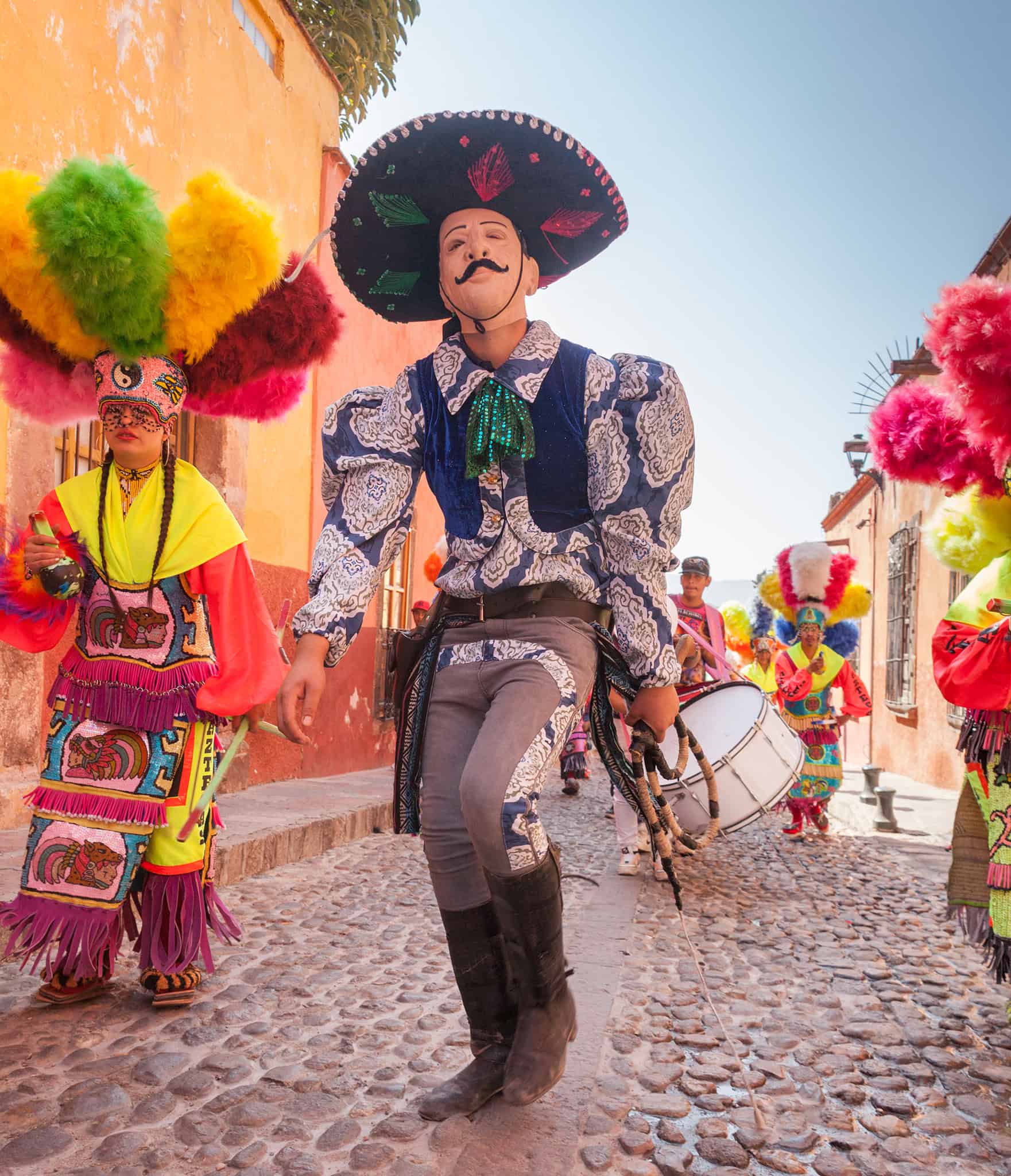 Colorful traditional Mexican dancers in vibrant costumes celebrating cultural festival in San Miguel.