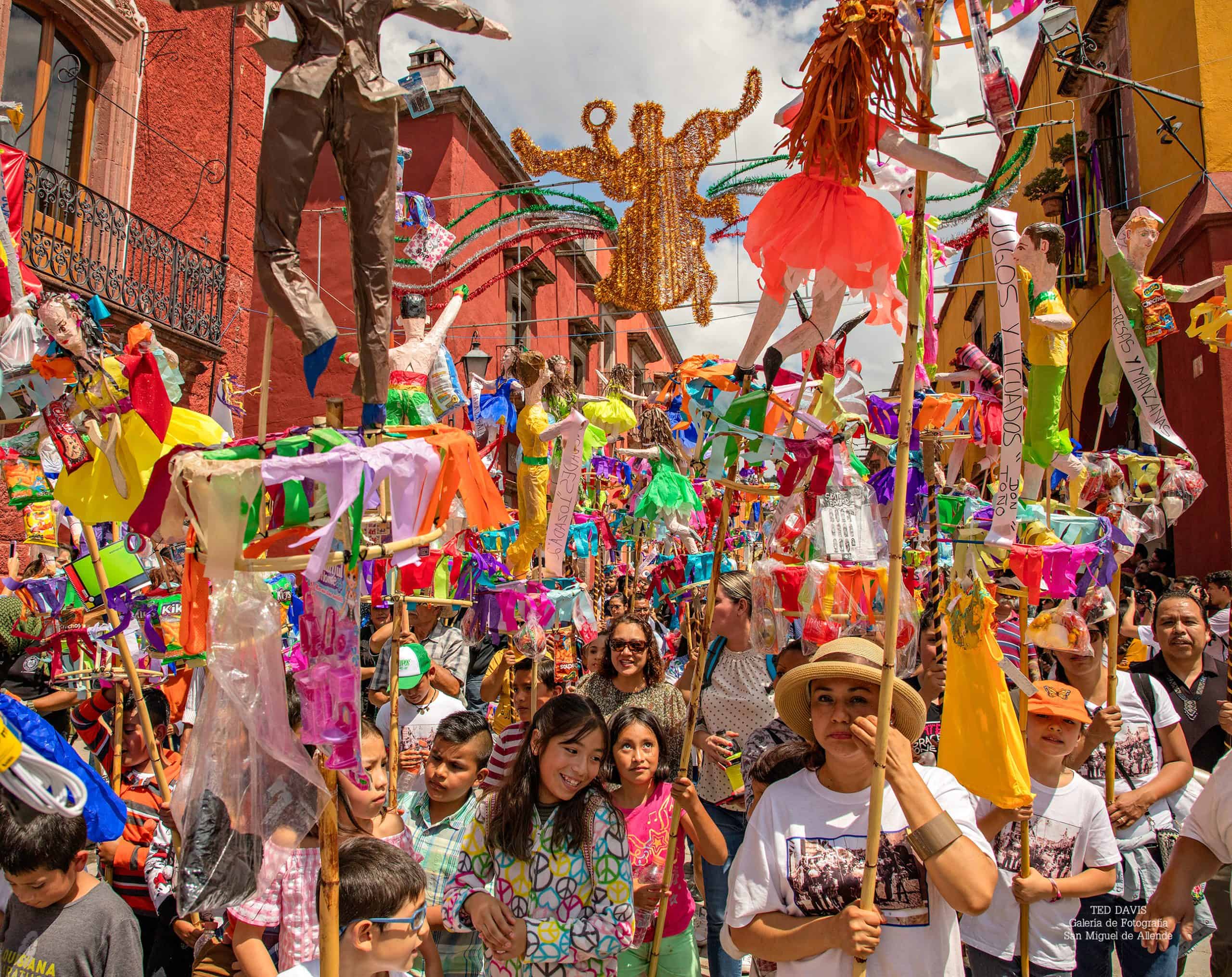 Colorful alebrijes and vibrant festivities at a San Miguel de Allende cultural celebration and parade.