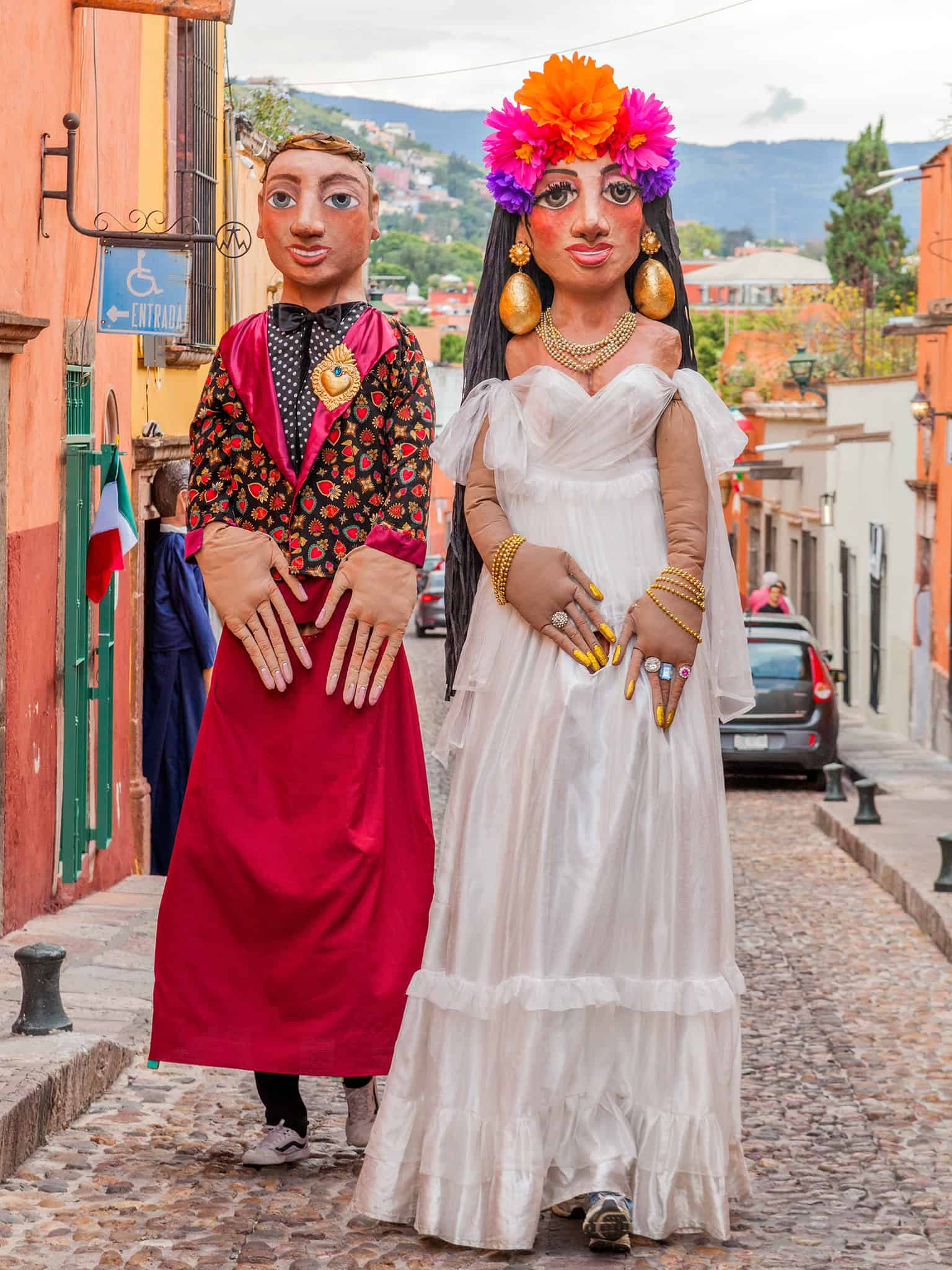 Vibrant Mexican puppets representing cultural heritage on cobblestone street in San Miguel de Allende.