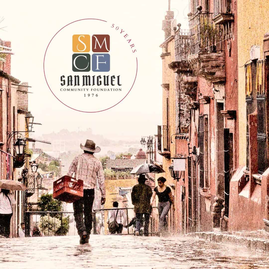 Rainy street scene in San Miguel de Allende with the San Miguel Community Foundation logo