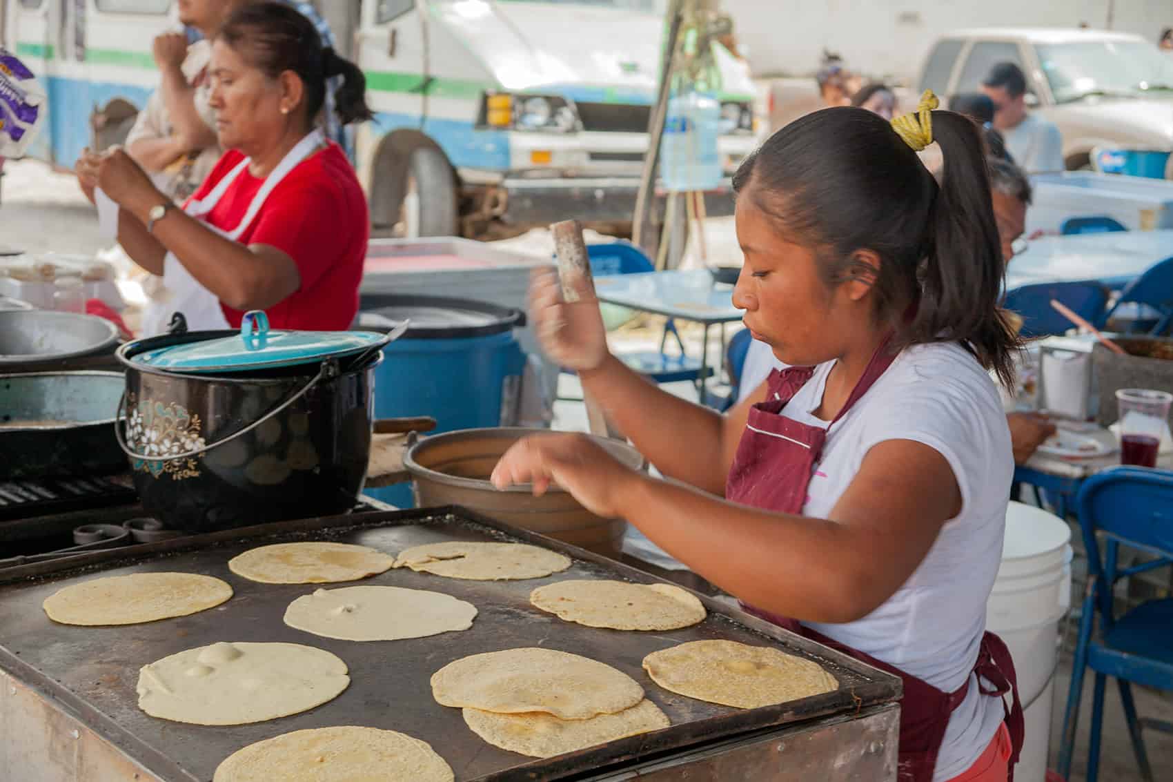 Freshly cooked tortillas being prepared at an outdoor market in San Miguel, showcasing traditional Mexican cuisine.
