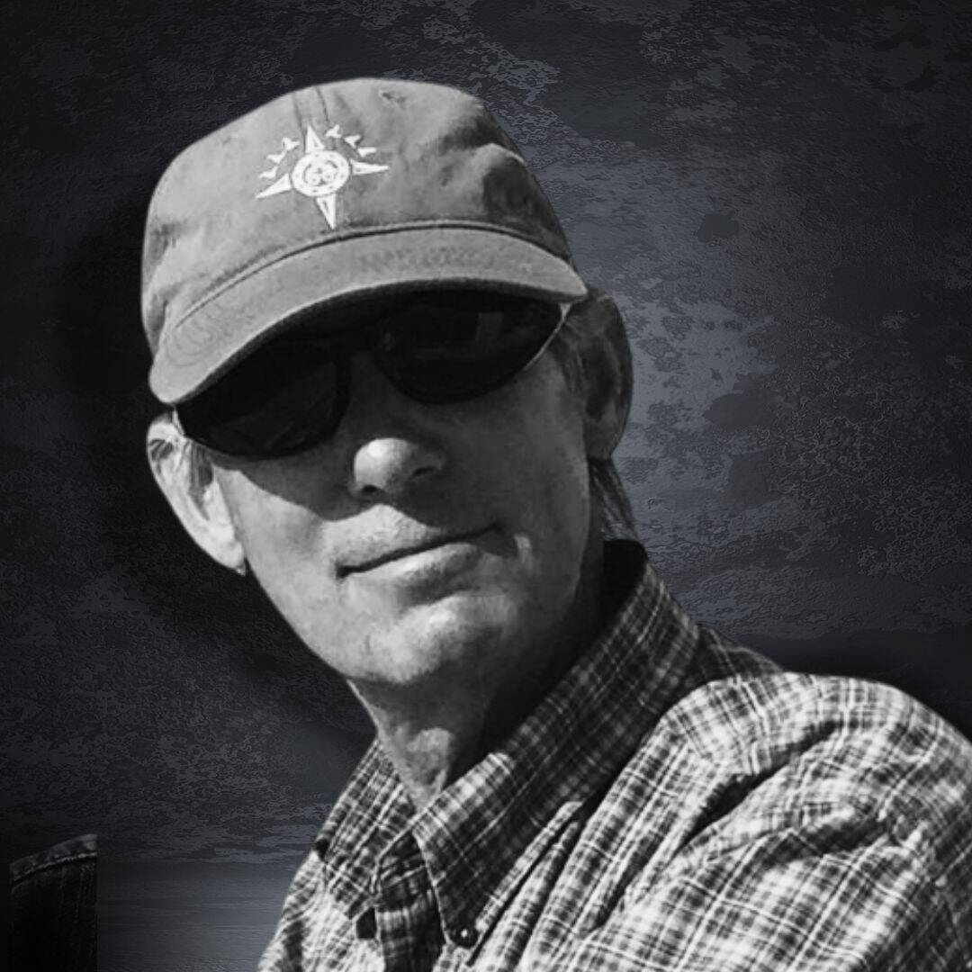 Stylish man wearing a cap and sunglasses, outdoor setting, black and white photo.