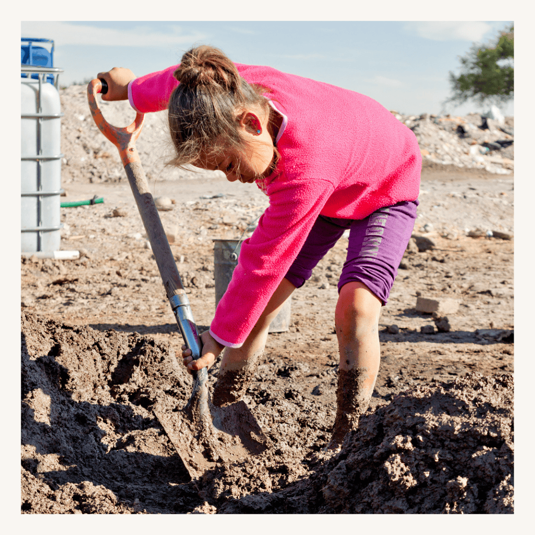 Child planting at construction site, featuring a SMCF Nonprofit Network Member organization.