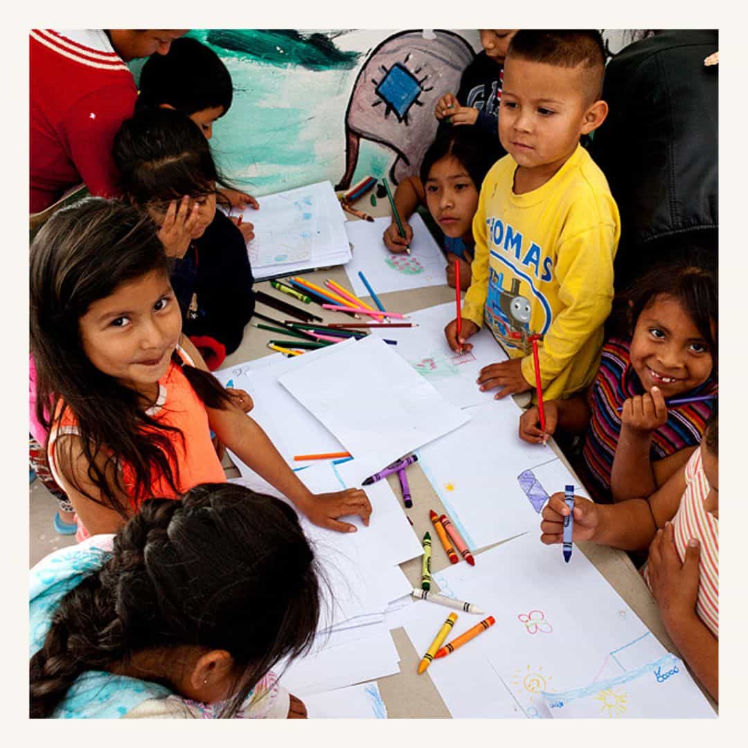 Children engaging in creative drawing, featuring the impact of a SMCF Nonprofit Network Member organization.