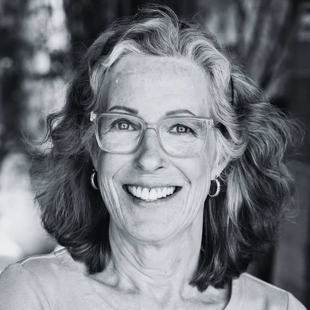 Empowered woman smiling confidently, representing leadership and strength.